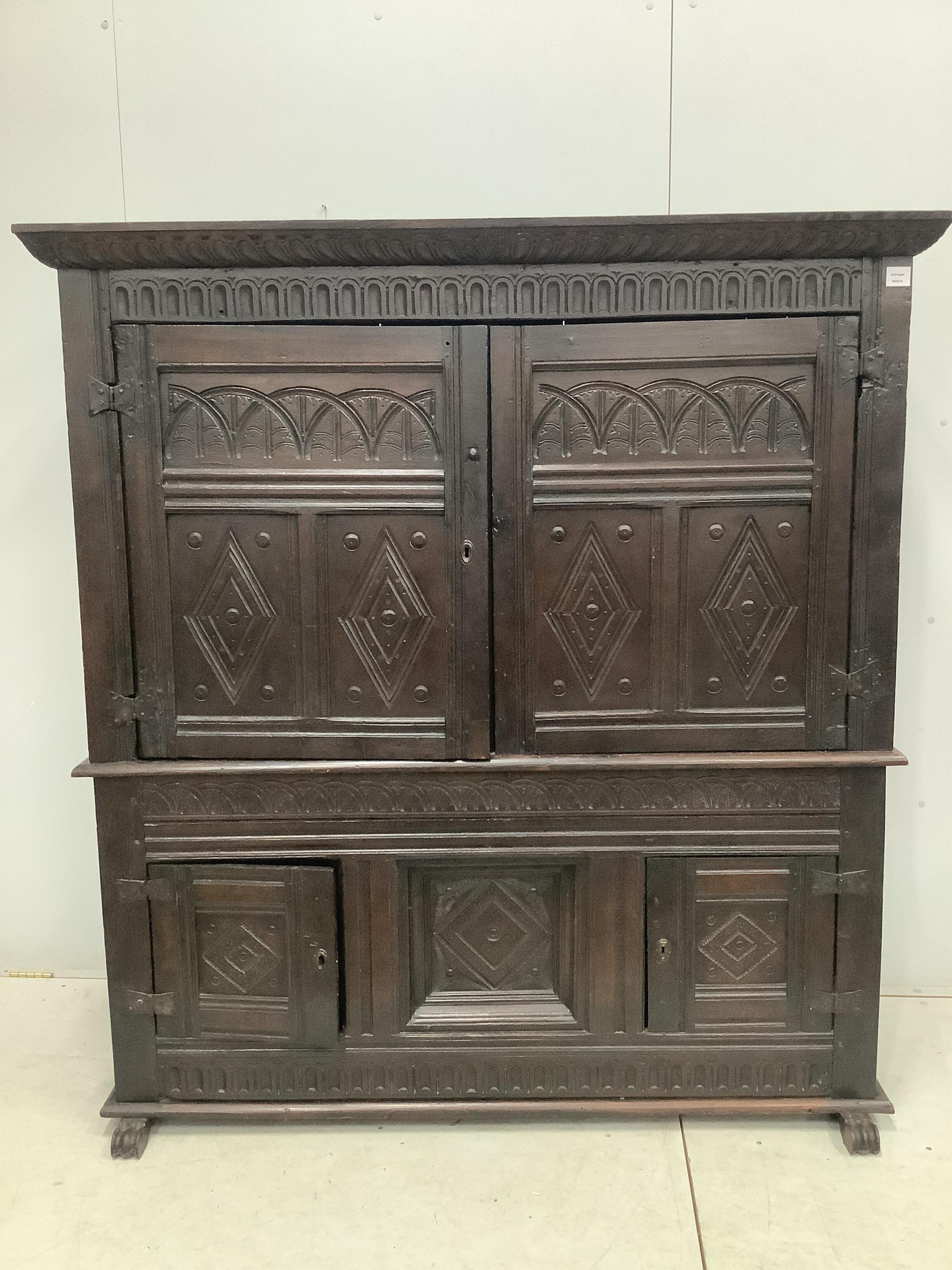 A late 17th century Continental carved oak two section cupboard, width 166cm, depth 57cm, height 167cm. Condition - fair